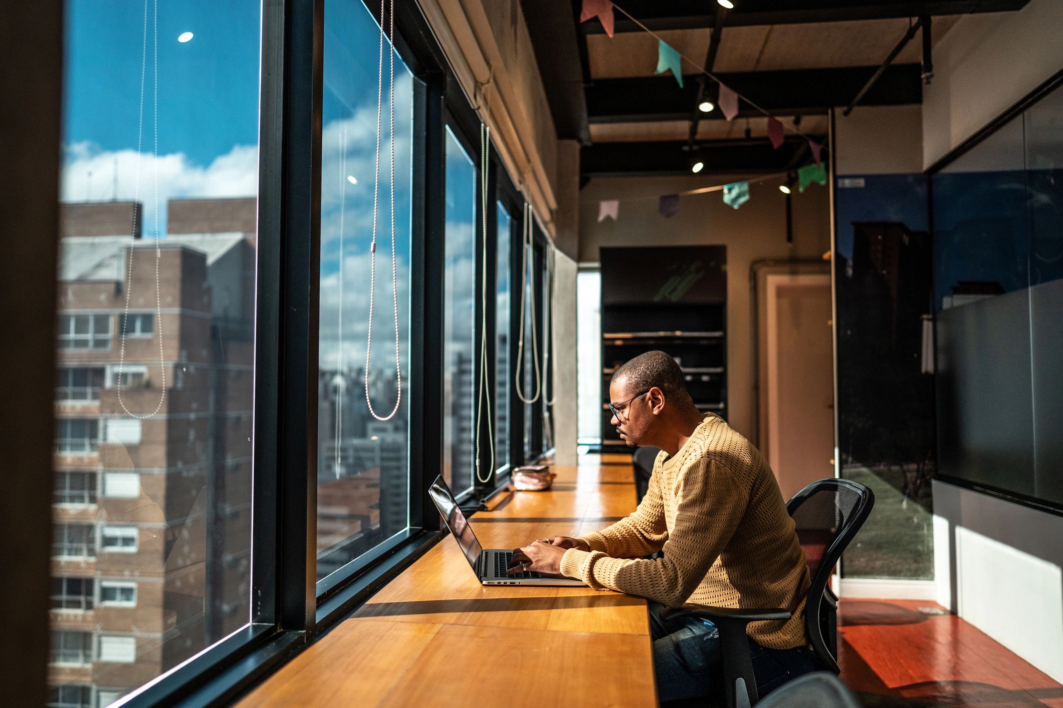 Developer working on a laptop in a modern workspace